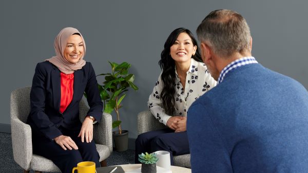 Business woman conversing with businessman.