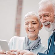 Business couple using phone on the street