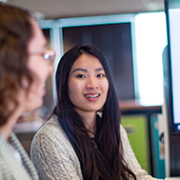 Young Asian woman presenting to her colleague.