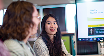 Young Asian woman presenting to her colleague.
