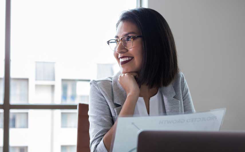 Professional woman looking to the side smiling.