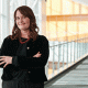 Monica Reha standing with arm crossed at Edward Jones headquarter.