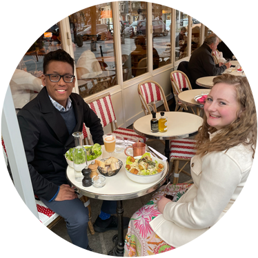 A man and women dining at a Parisian café.