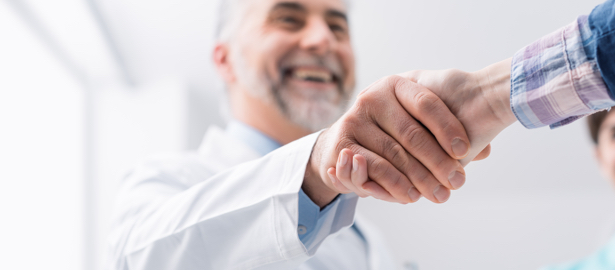 Male clinician shaking hands with patient.