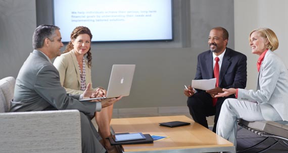 Two men and two women seated across from one another having a discussion.